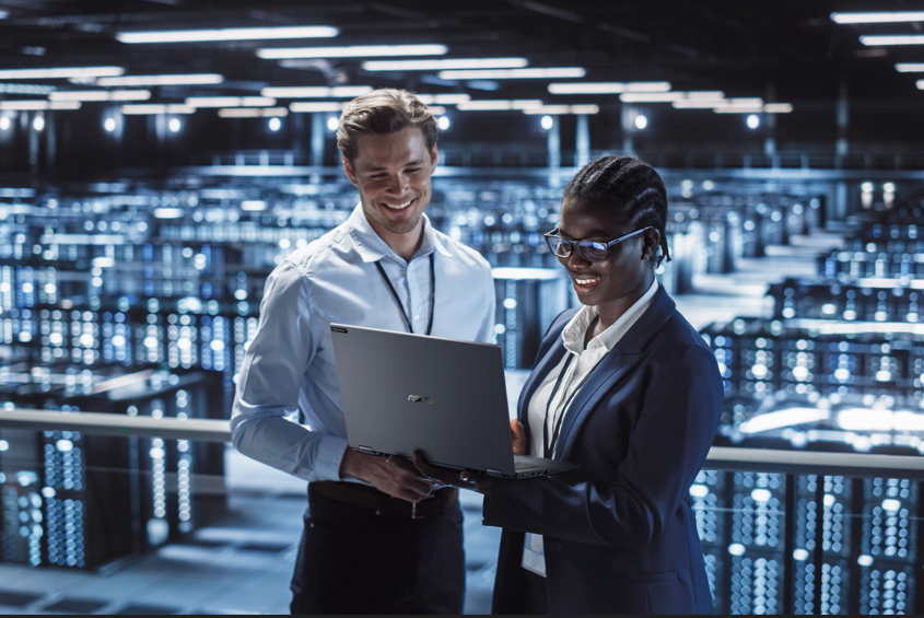 A few business people looking at a computer Description automatically generated with low confidence